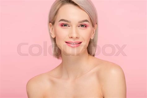 beautiful happy naked girl with pink makeup isolated on pink stock