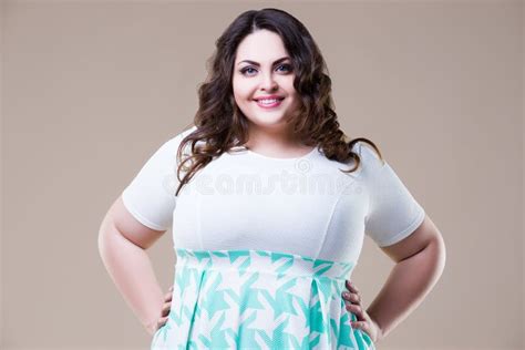 happy plus size fashion model in casual clothes fat woman on beige