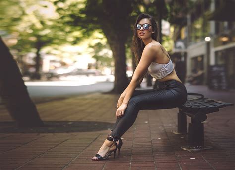 4559023 street women women with glasses legs sitting high heels sunglasses long