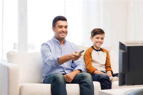 smiling father and son watching tv at home stock image image of happy male 69408871