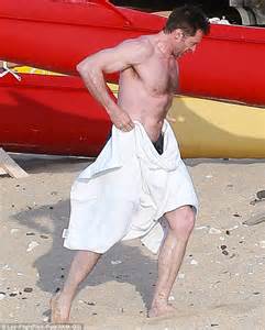 hugh jackman shows off his bulging biceps and ripped abs as he goes