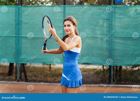 Professional Equipped Female Tennis Player Beating Hard The Tennis Ball