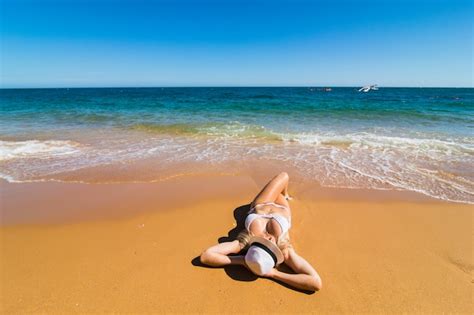 photo top aerial drone view  woman  swimsuit bikini relaxing  sunbathing  beach