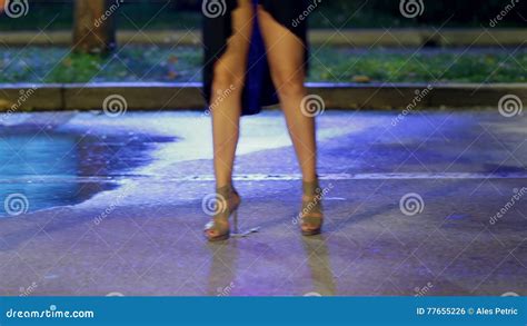women with long legs in high heels and miniskirts are dancing stock