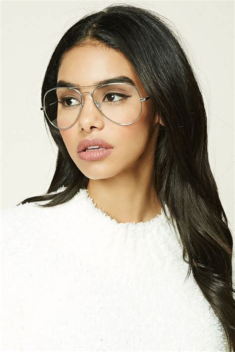 A Pair Of Reader Glasses Featuring Aviator Frames And Clear Lenses