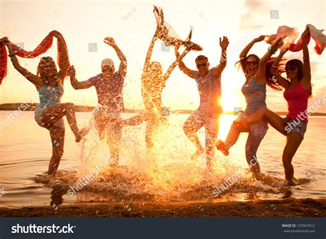 large group  young people enjoying  beach party stock photo  shutterstock