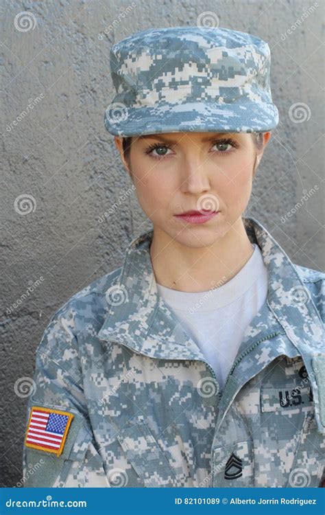 Brunette Woman With Usa Flag On Army Uniform Posing At Gray Wall Stock