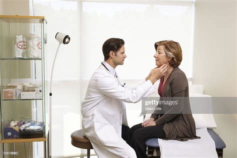 male doctor exams female patient photo getty images