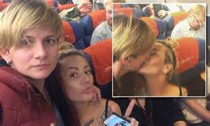 lesbian couple sat by anti gay russian politician pose for