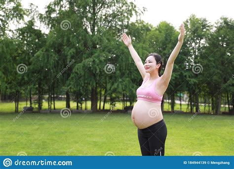 asian eastern chinese happy beautiful pregnant woman hug embrace nature