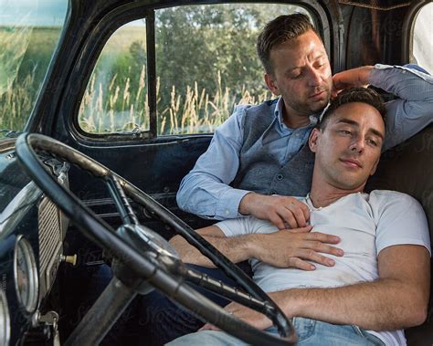 Gay Men Cuddling Romantically In Vehicle Stocksy United