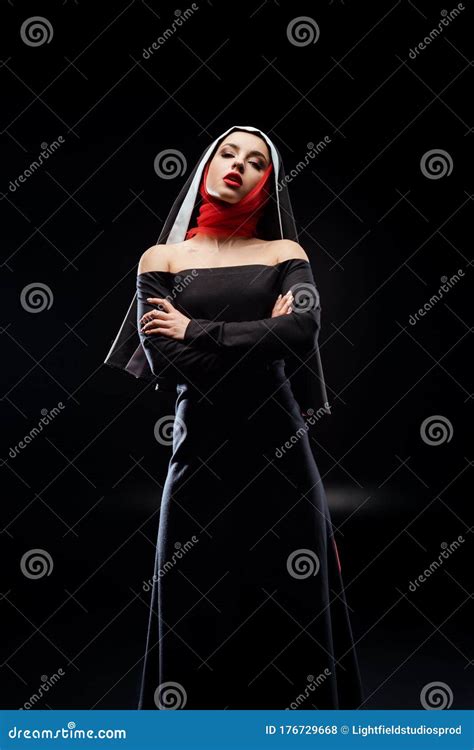 Beautiful Nun Posing In Black Dress And Red Scarf Standing With Crossed
