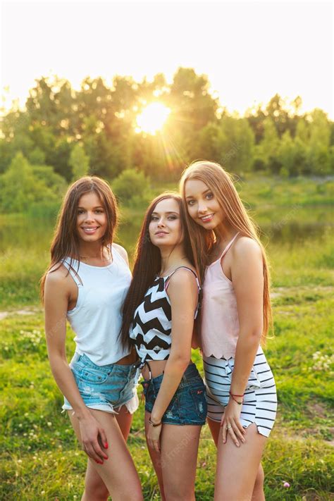 premium photo three beautiful girls walking and laughing on sunset in
