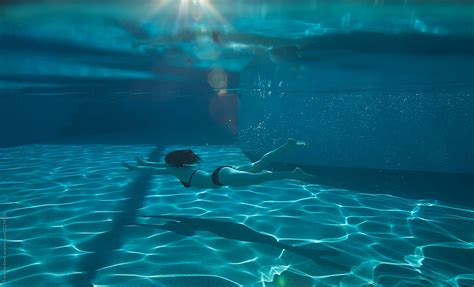 Woman Swimming Under Water In Swimming Pool Del Colaborador De