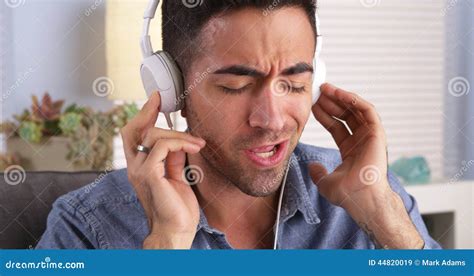 handsome mexican guy listening   stock image image  jamming contemporary