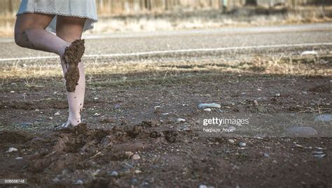 woman walking barefoot in mud photo getty images