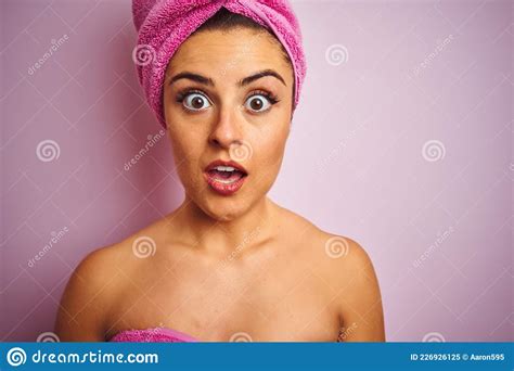 Young Beautiful Woman Wearing Towel After Shower Over Isolated Pink