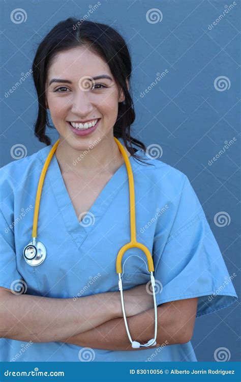 Attractive Female Hispanic Doctor Or Nurse Isolated On A Blue
