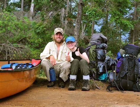 people sitting    canoe  backpacks   ground