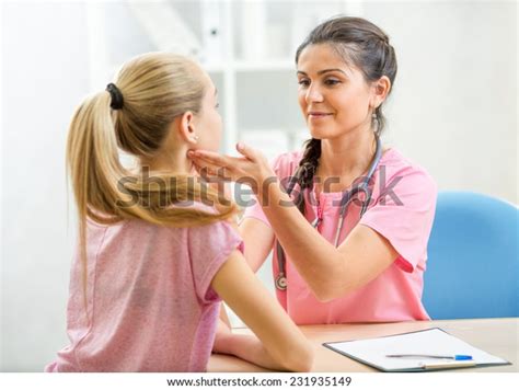 female doctor examining teenager patient office stock