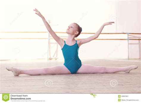 Flexible Little Ballerina Posing Sitting On Split Stock