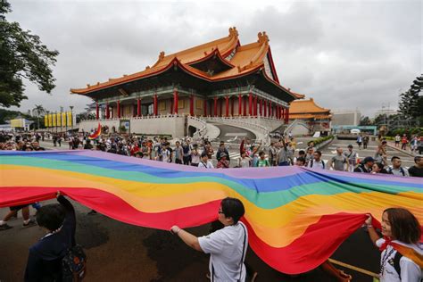 taipei raises rainbow flag at city hall as thousands march
