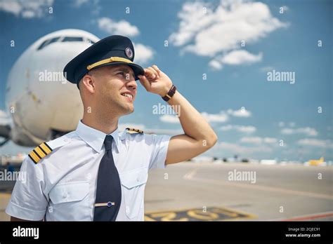 handsome male pilot standing outdoors  airport stock photo alamy