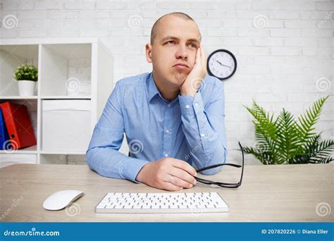 young bored man sitting   office stock photo image  exhausted