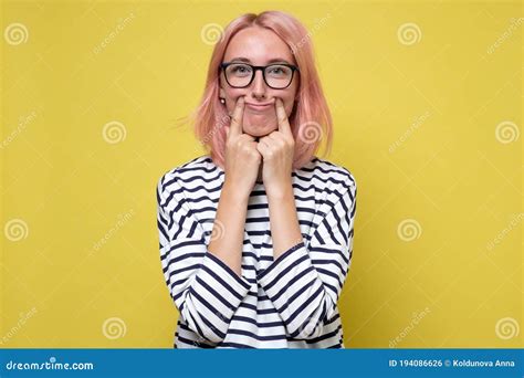 Woman Making Fake Smile With Her Fingers Stretching The Corners Of Her