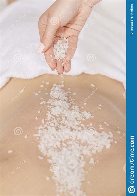 Spa Scrub Massage Hands Sprinkle Salt On Back Of Girl Stock Image