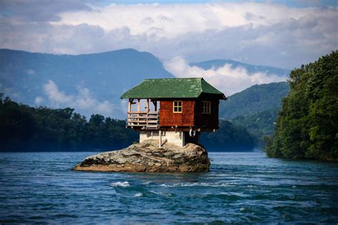man built  isolated house   middle   raging river video
