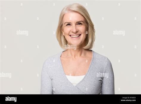 Smiling Mature Woman Looking At Camera Isolated On Grey Background
