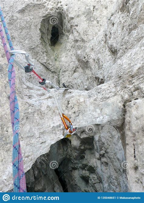 placing mobile rock climbing protection   natural  obvious rock tunnel stock image image