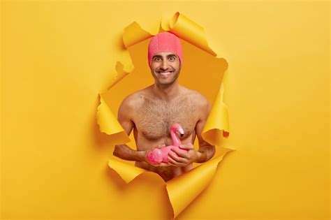 free photo pleased smiling man with naked torso wears pink rubber