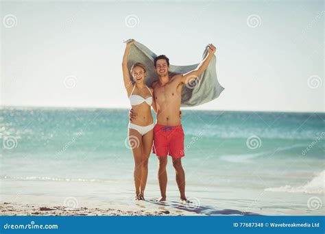 couple holding towel  beach stock photo image  holiday holding