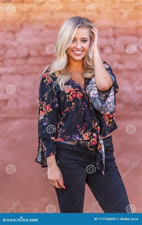 a lovely blonde model enjoys an autumn day outdoors in a small town