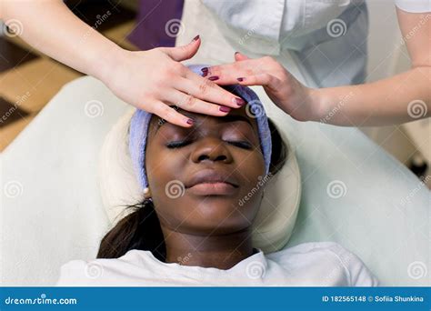 Beautiful African American Girl Having Facial Massage With Closed Eyes