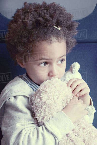 girl holding stuffed toy portrait stock photo dissolve