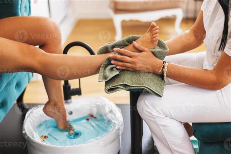 woman enjoying pedicure spa treatment   beauty salon  stock