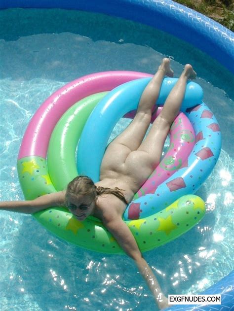 nude blonde gf having fun in the inflatable pool photo