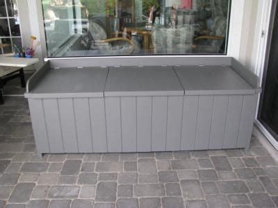 large gray bench sitting  front   glass window   side