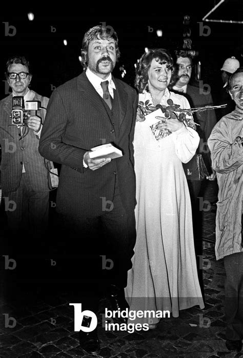 image of robert oliver reed with his wife kate byrne outside of