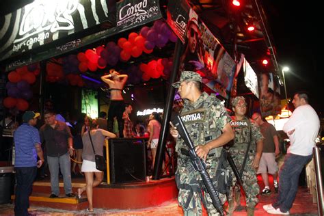 youths flood cancun under watch of marines police cbs news