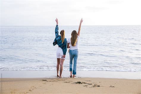 two cool girls enjoying the view and sharing a moment at the beach by