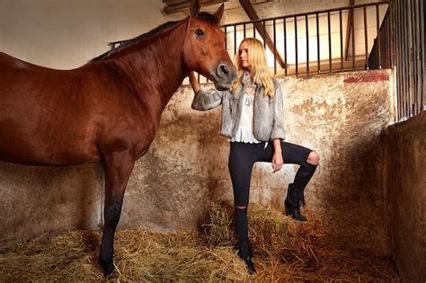 premium photo blond woman   indoor stable  horse