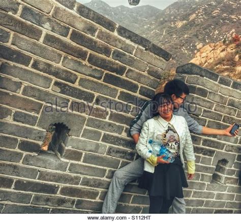 chinese couple taking a selfie on the greag wall of china