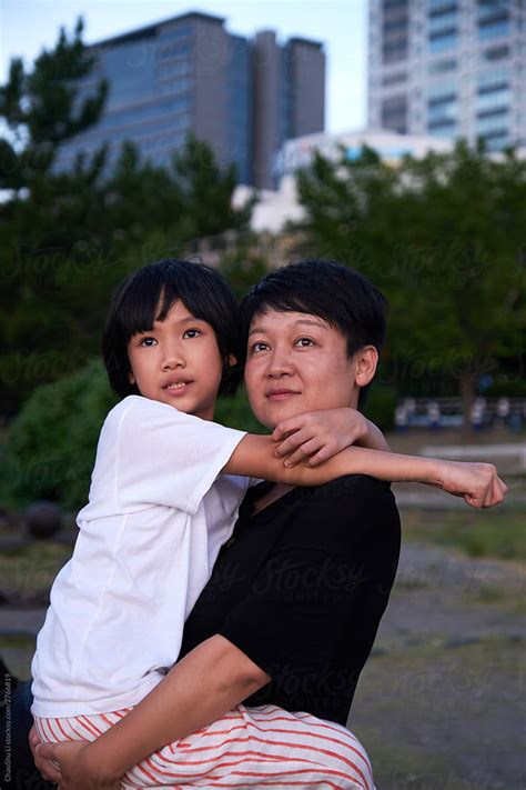 Asian Mother And Daughter Holding Each Other At The Seaside In Tokyo