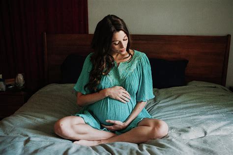 pregnant woman in bed photograph by cavan images fine art america