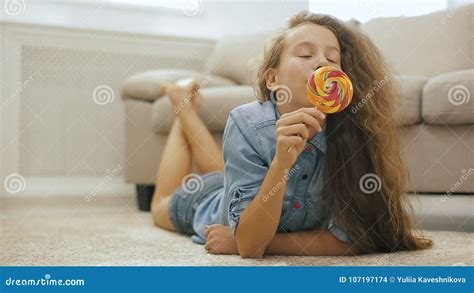 beautiful fair haired teen girl with candy playful cute girl with big