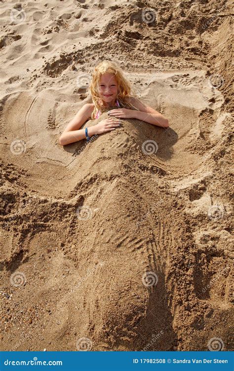 girl buried  sand stock photo image  holiday